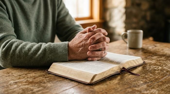 man crossing his hands and praying